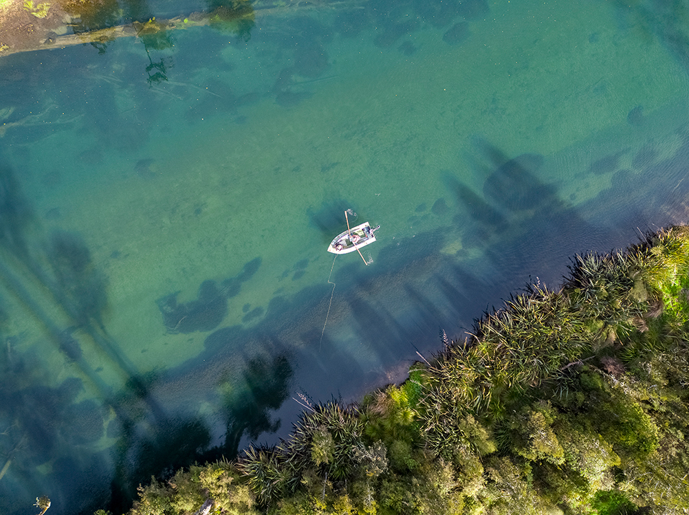 A fishing boat on the blue water in Fiordland.